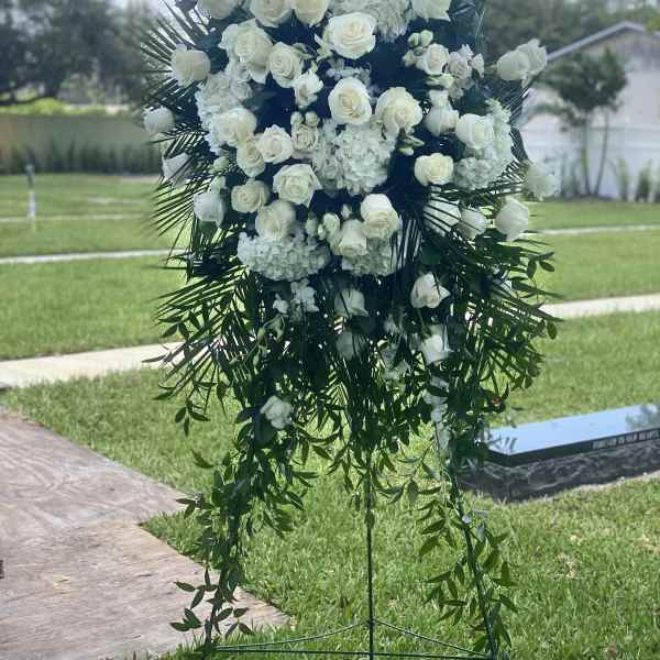 Large white floral standing spray with roses and cascading greenery