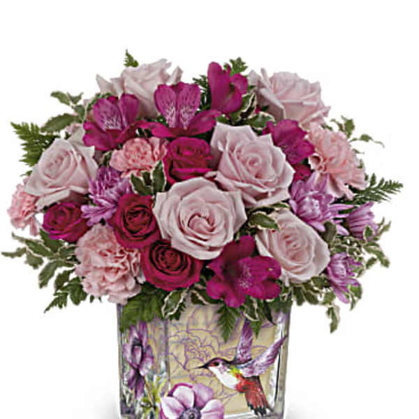 Pink and white rose bouquet in a decorative glass vase