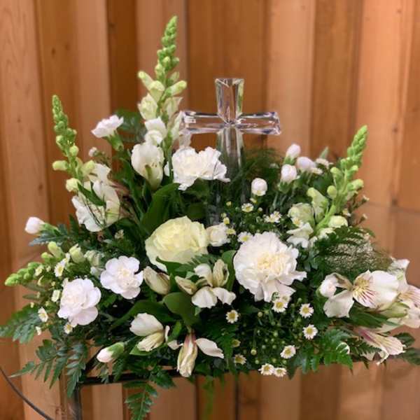 White floral arrangement with a clear cross centerpiece
