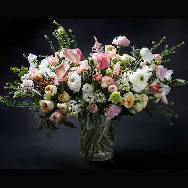 Mixed pink and white flowers in a clear glass vase
