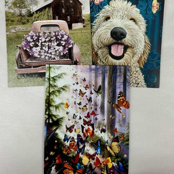 Three decorative cards with a dog, butterflies, and a flower-covered truck