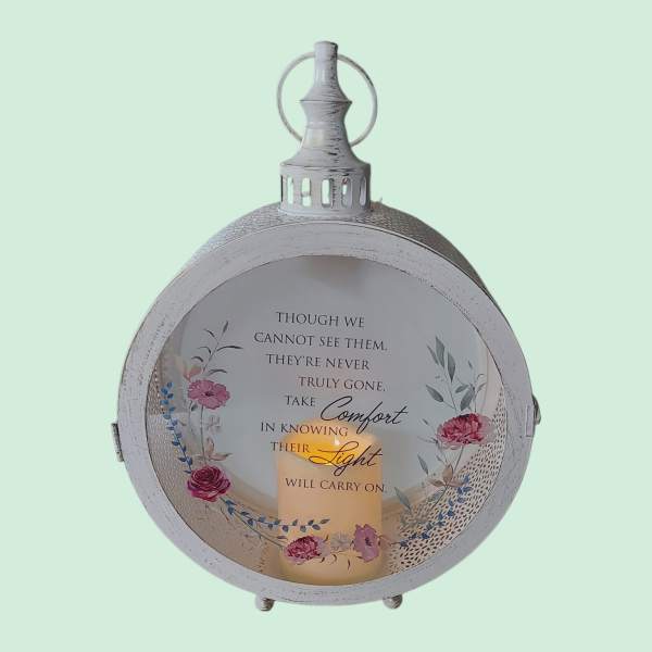 Decorative lantern with a memorial quote and floral accents