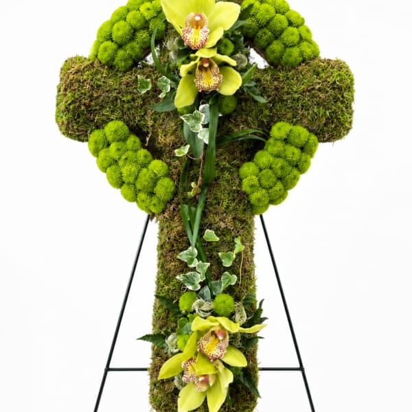 Green floral cross on a black stand with yellow orchids
