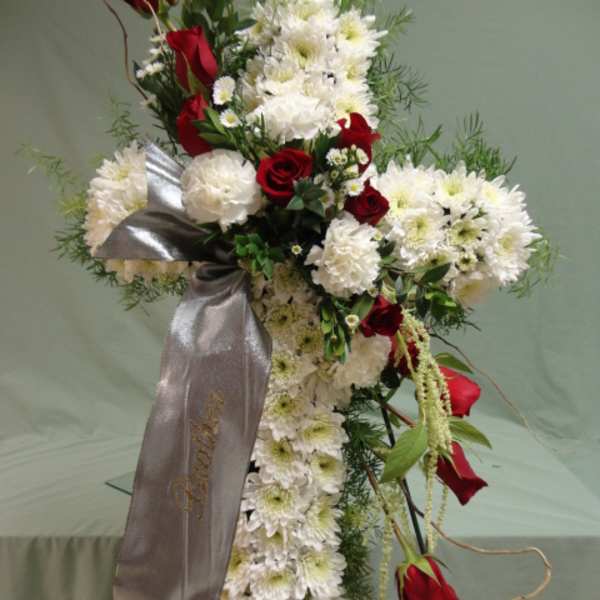 Standing floral spray with white chrysanthemums and red roses, accented by a silver ribbon