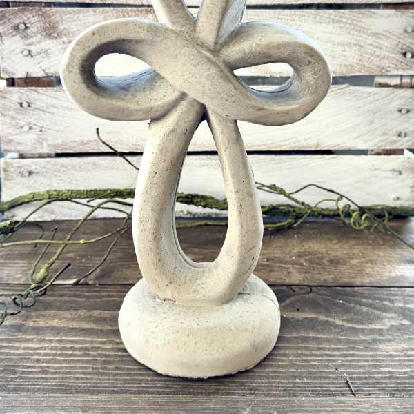 Stone knot sculpture on a wooden surface