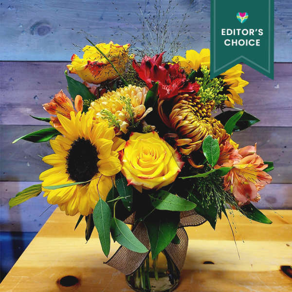 Bouquet of yellow and red flowers in a glass vase