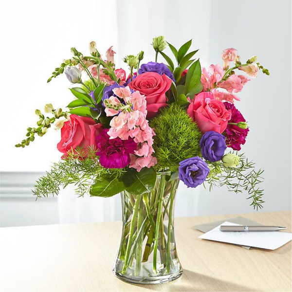 Mixed pink and purple bouquet in a clear glass vase