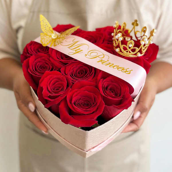 Heart-shaped box of red roses with a "My Princess" ribbon and gold crown toppers