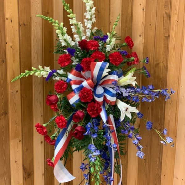 Tall red, white, and blue floral standing spray with ribbon
