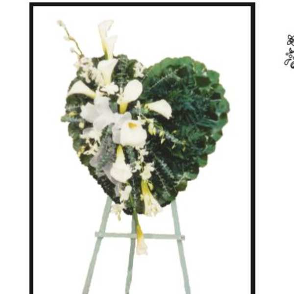 Heart-shaped floral wreath with white calla lilies on an easel