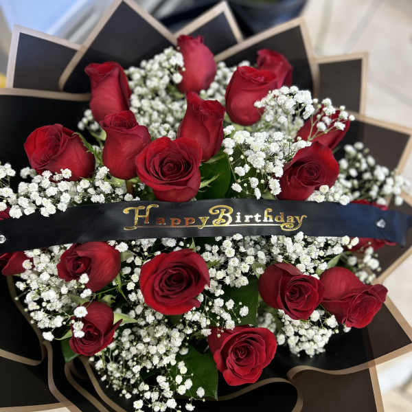 Bouquet of red roses with white baby's breath and a Happy Birthday ribbon