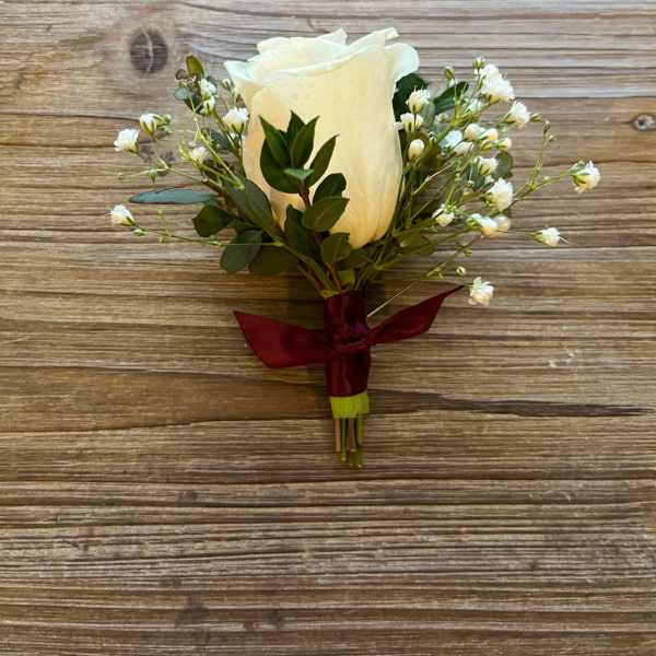White rose boutonniere with baby's breath and burgundy ribbon