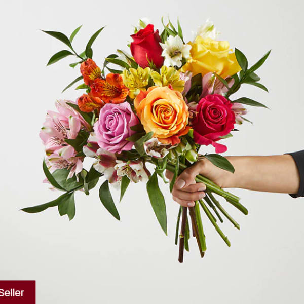 Handheld bouquet of multicolored roses and alstroemeria