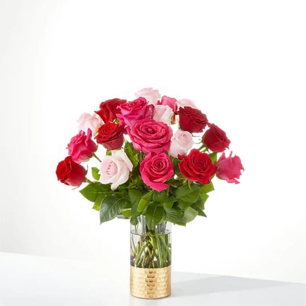 Bouquet of pink and red roses in a clear glass vase