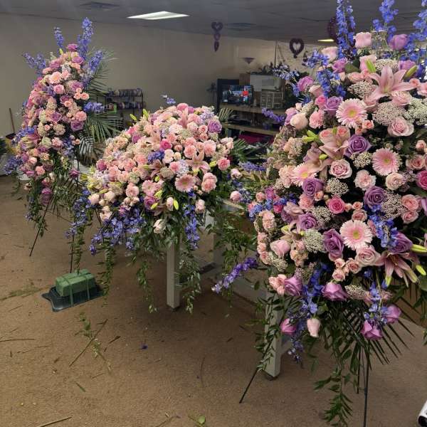 Large floral sprays in pink, lavender, and blue on stands