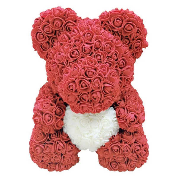 Teddy bear made of red roses with a white heart on its chest