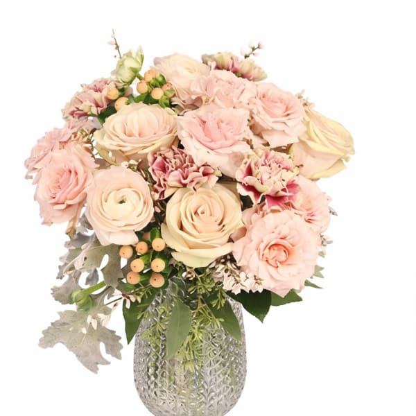 Blush roses and carnations in a textured glass vase