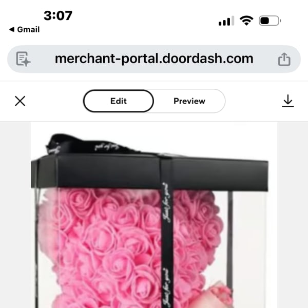 Pink rose teddy bear in a black gift box with a ribbon