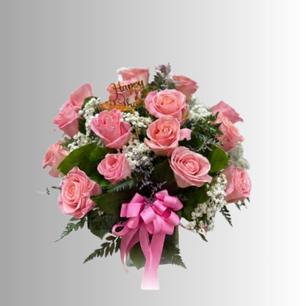 Pink rose bouquet with a pink ribbon in a glass vase