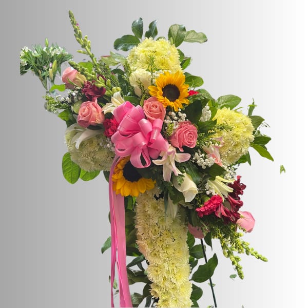 Large bouquet with pink roses, sunflowers, and yellow chrysanthemums tied with a pink ribbon