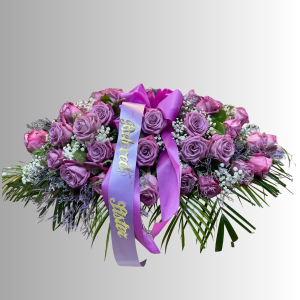 Lavender and pink rose arrangement with a purple ribbon