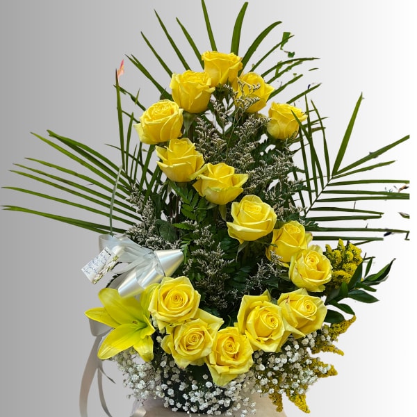 Tall bouquet of yellow roses with a yellow lily and white filler flowers