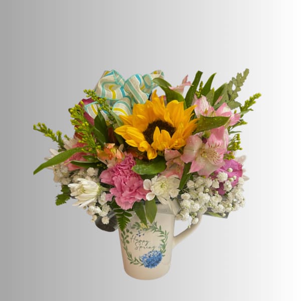Mixed bouquet with a sunflower in a decorative mug vase