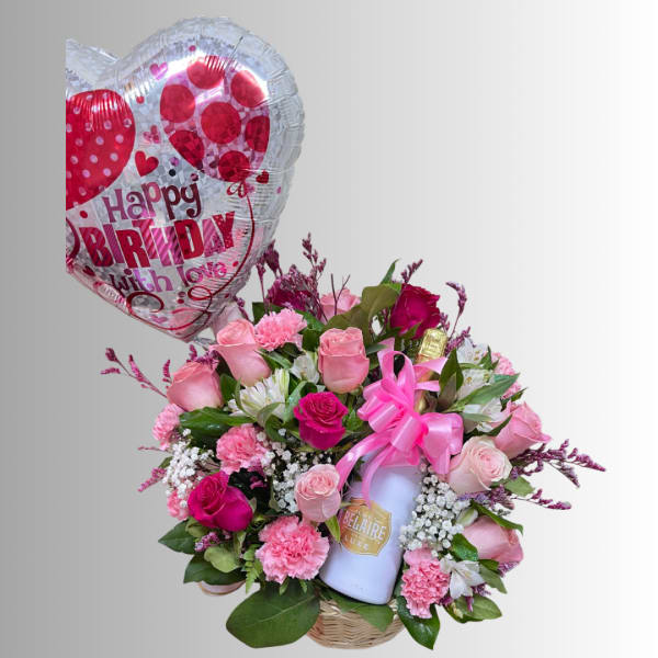Pink rose bouquet with a birthday heart balloon and a bottle in a basket