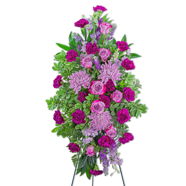 Tall standing floral spray with pink roses, lavender blooms, and magenta carnations