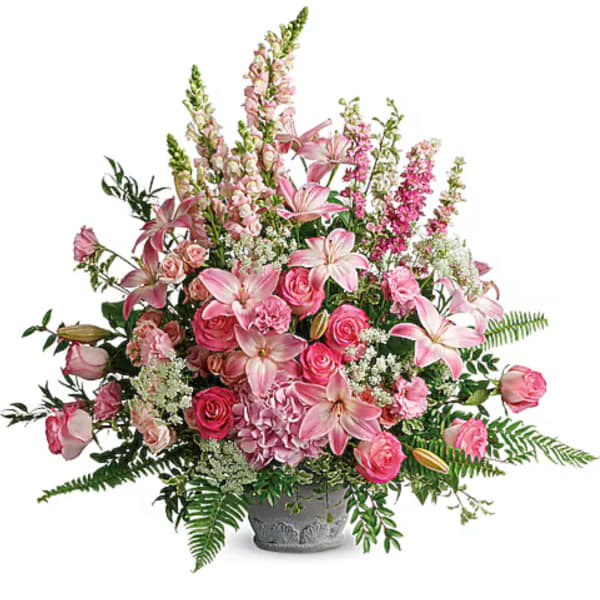 Pink lilies and roses arranged in a gray vase