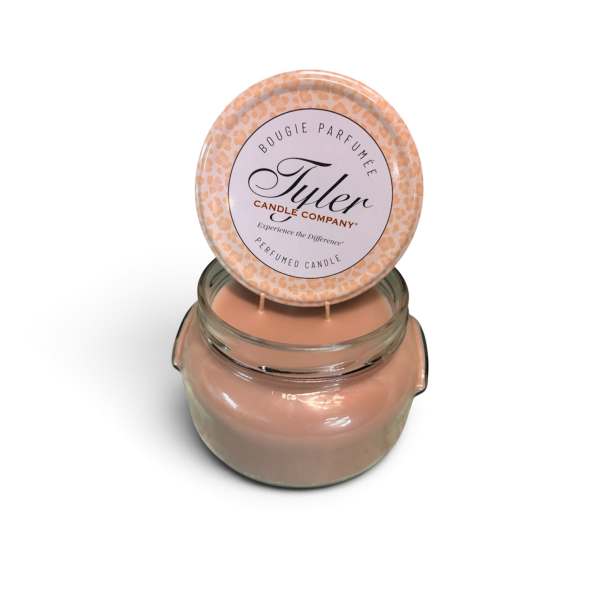 Peach scented candle in a glass jar with a round lid