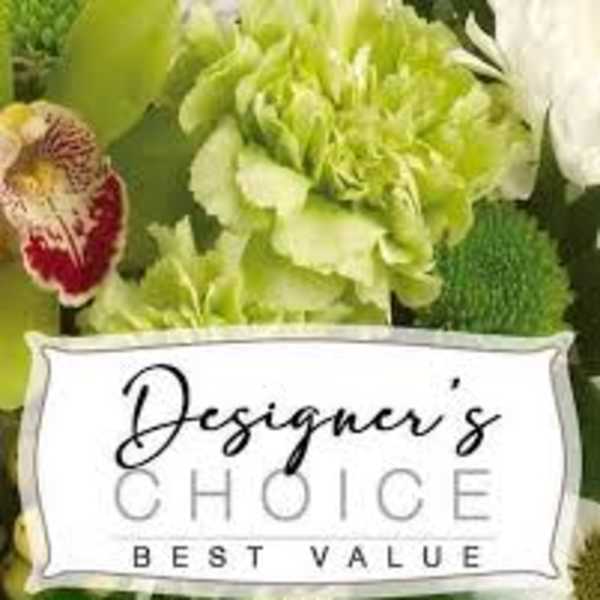 Green and white floral arrangement with a St. Patrick's Day sign