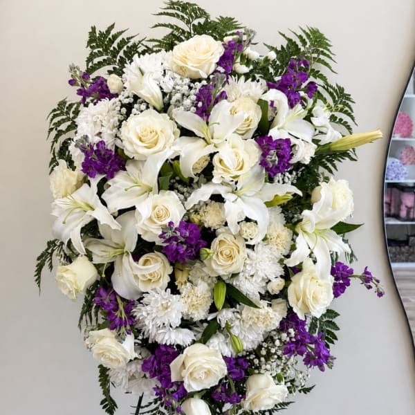 White and purple floral arrangement with roses and lilies