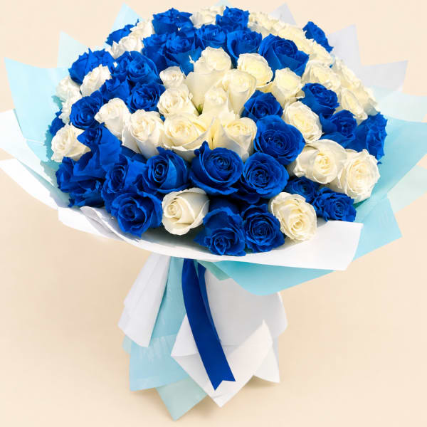 Bouquet of blue and white roses wrapped in pale blue and white paper