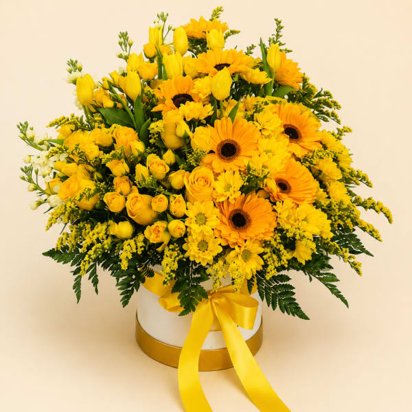 Yellow bouquet with roses, tulips, and daisies in a white hat box with ribbon