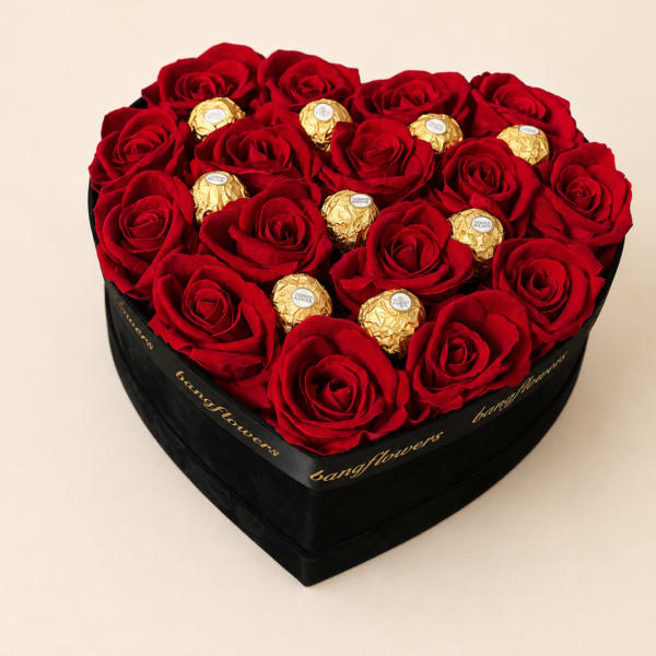 Heart-shaped box of red roses with gold-wrapped chocolates