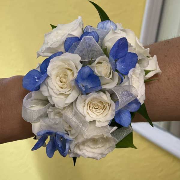 White and blue rose wrist corsage with silver ribbon