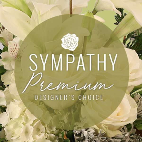 White sympathy floral arrangement with lilies and roses