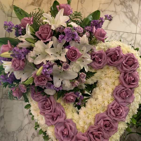 Heart-shaped floral arrangement with lavender roses and white lilies