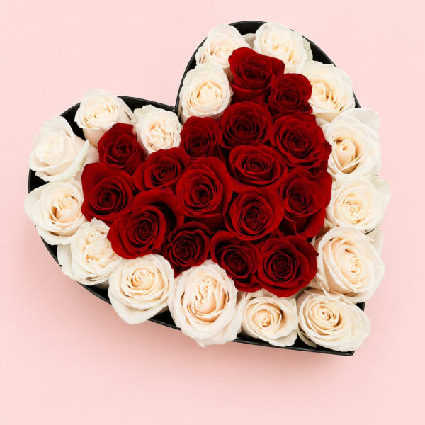 Heart-shaped box filled with red and white roses