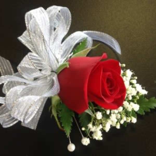 Red rose boutonniere with white baby's breath and silver ribbon