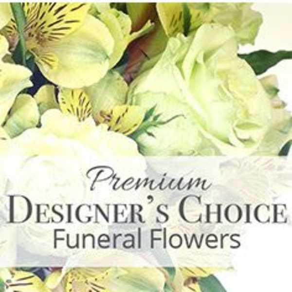 Soft yellow and cream flowers with a Premium Designer's Choice Funeral Flowers text overlay