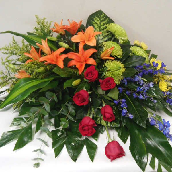 Mixed bouquet with orange lilies, red roses, and blue flowers
