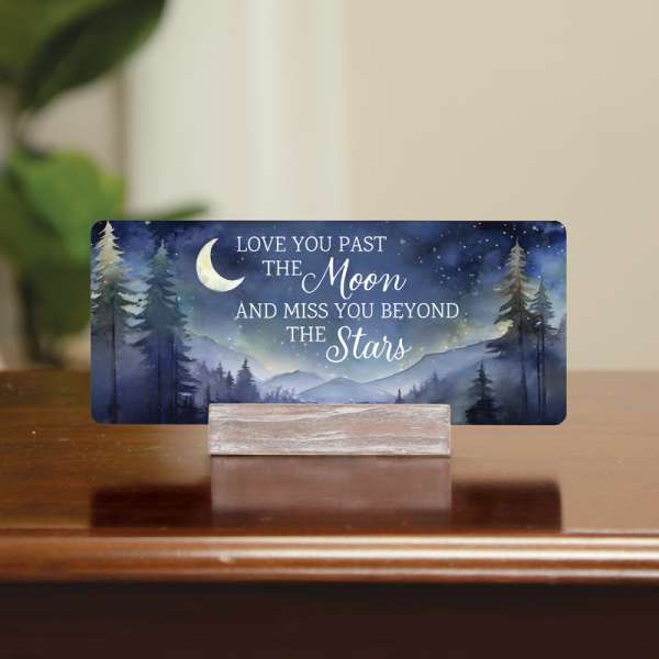 Memorial card with moon and stars on a wooden stand
