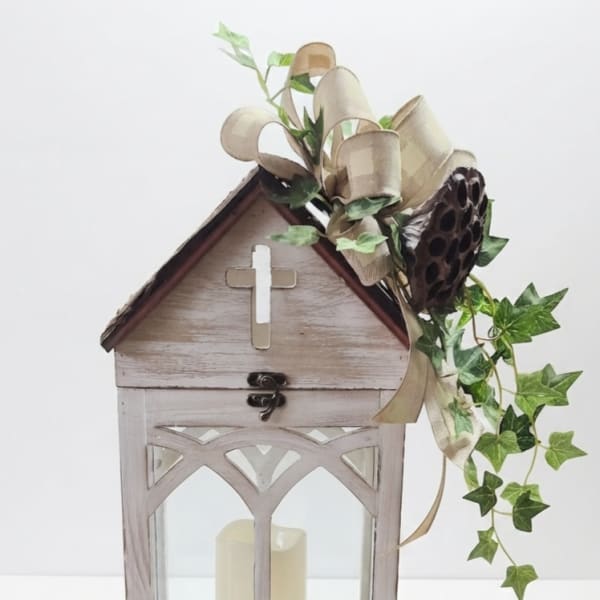 Wooden lantern with a candle and ivy ribbon decoration