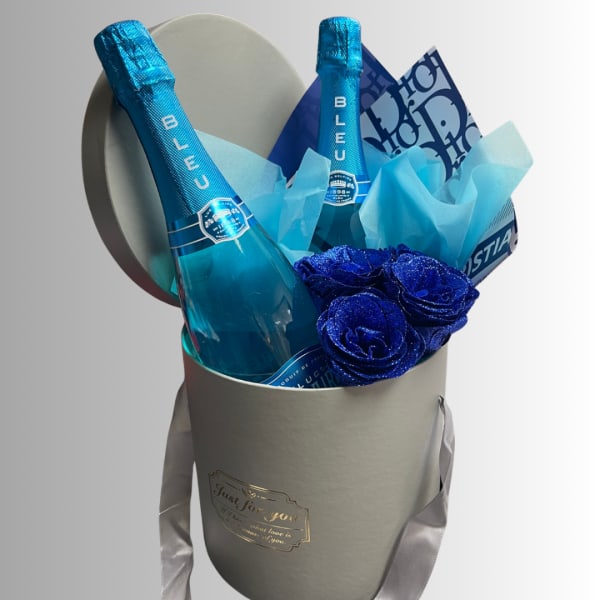Gift box with two blue champagne bottles and glittery blue roses