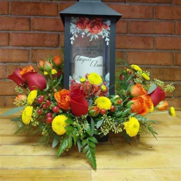 Floral arrangement around a black lantern with a candle inside