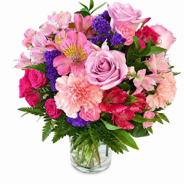 Pink and purple mixed bouquet in a clear glass vase