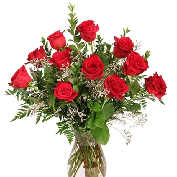 Red roses arranged in a clear glass vase