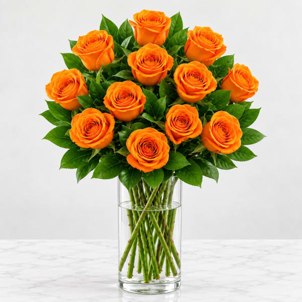 Orange roses arranged in a clear glass vase
